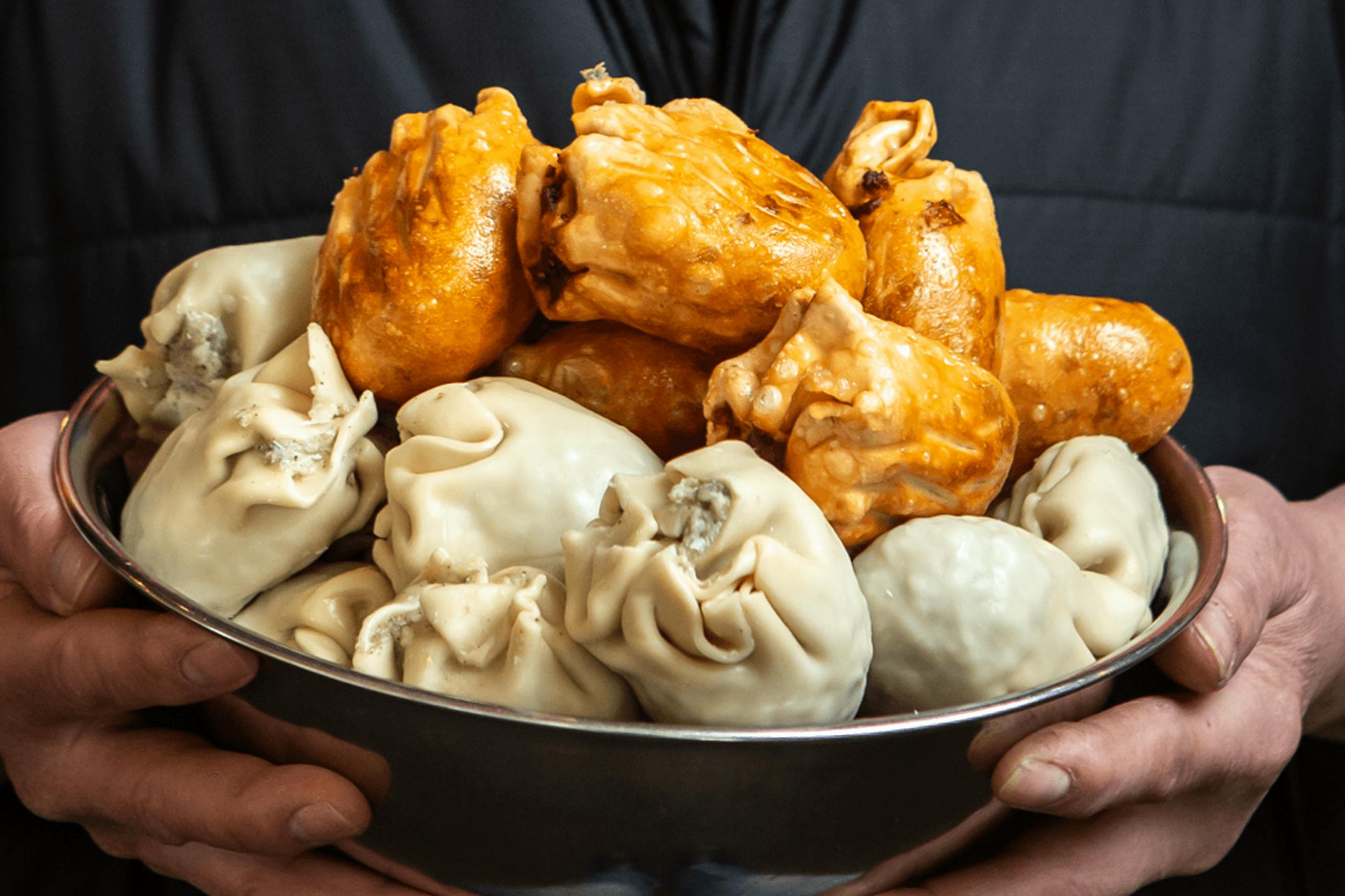 A bowl of fried and uncooked dim sims.